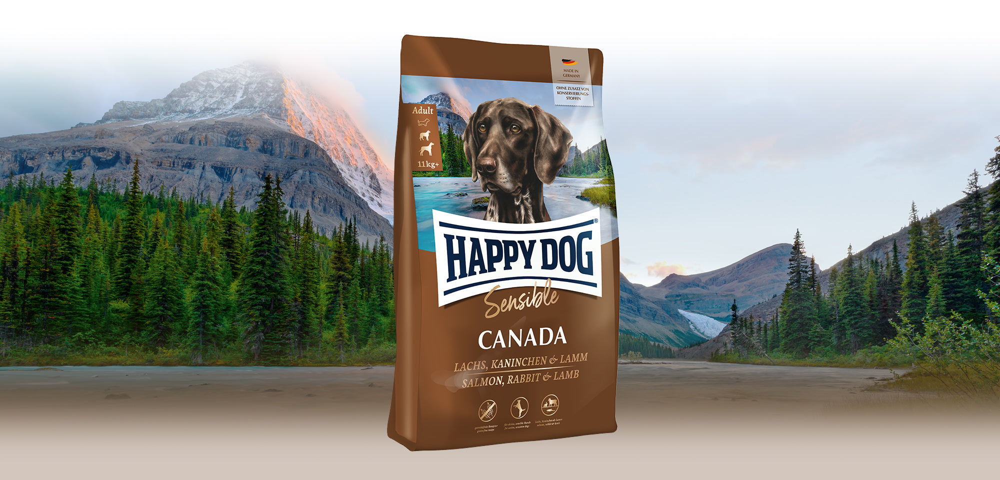 Das Hundefutter Happy Dog Sensible Canada vor einer unberührten kanadischen Berglandschaft.
